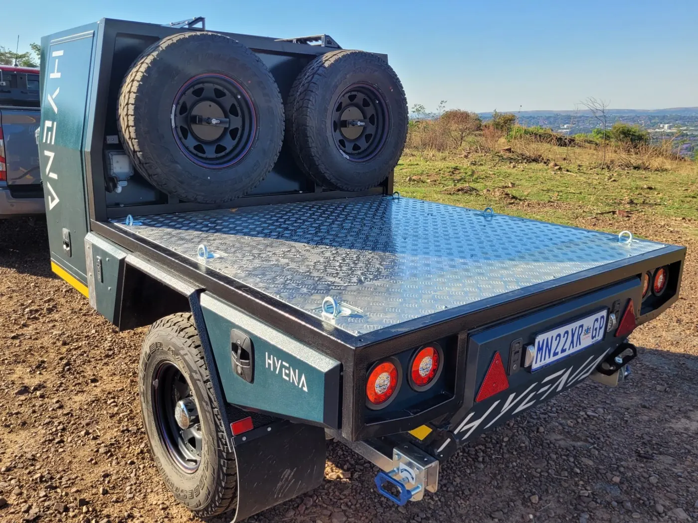 Hyena S1 flatbed conversion with treadplate deck and dual spare tyres