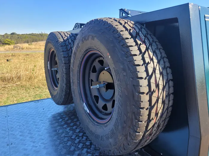 Hyena S1 flatbed with all-terrain spare tyres mounted