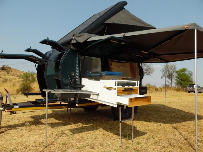 Hyena S1 fully set up campsite with kitchen and awning deployed